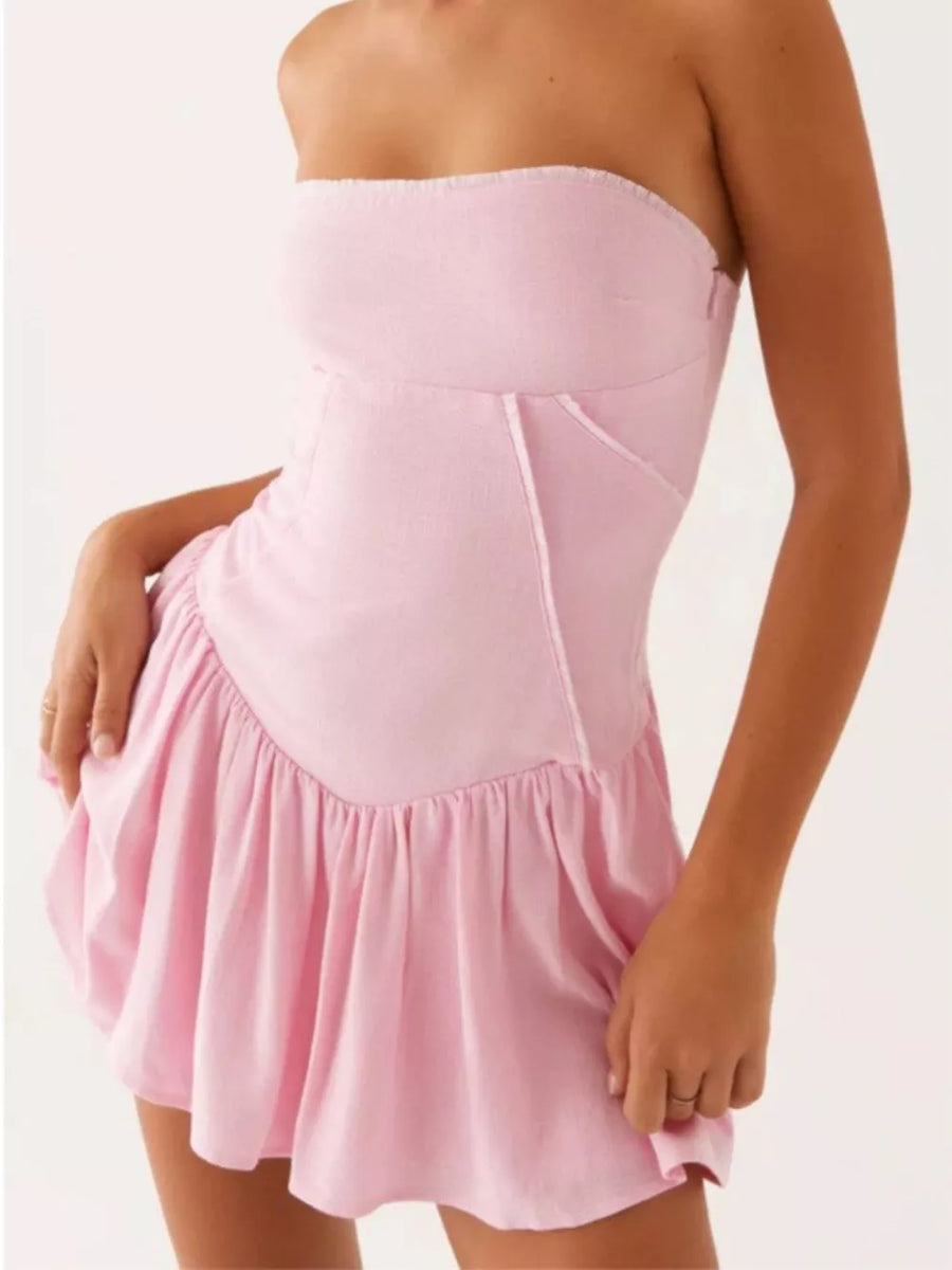 Blush pink ruffled tube dress with back tie detail and sweetheart neckline