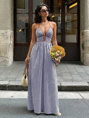 Elegant halter neck striped maxi dress with plunging neckline and brown trim.