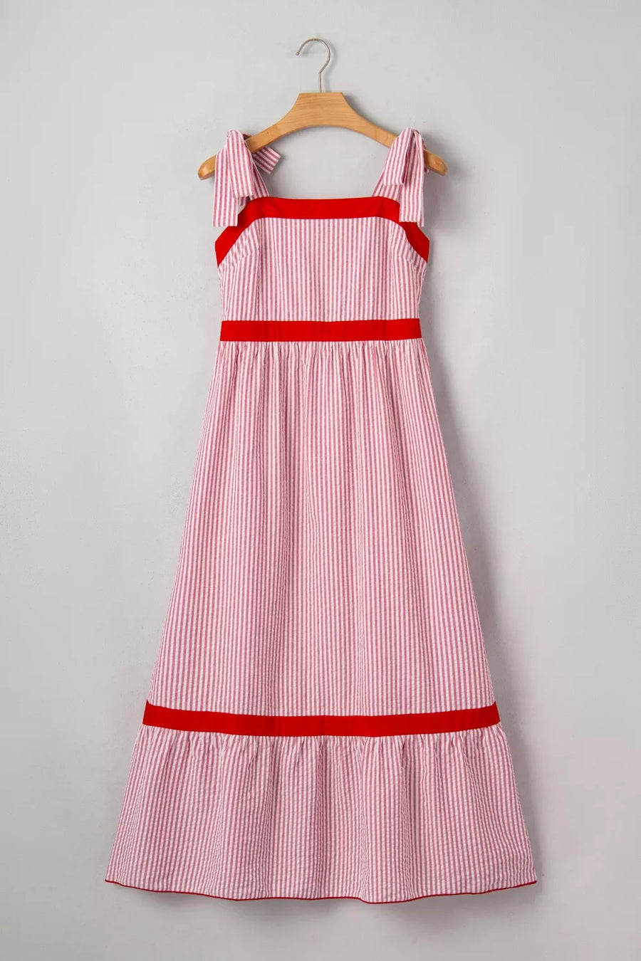 Maxi dress with red stripe pattern, bow knot straps, square neckline, and red trim details.
