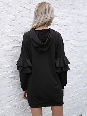 Black hooded mini dress with tiered ruffle trim sleeves.