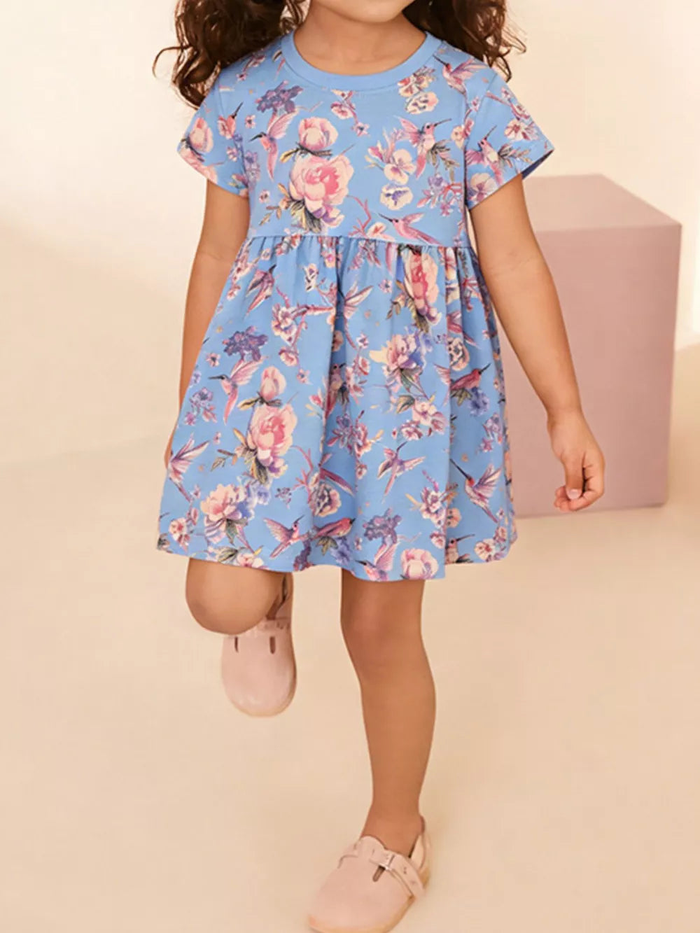 Baby girl's blue cotton blend a-line dress with floral and hummingbird print.