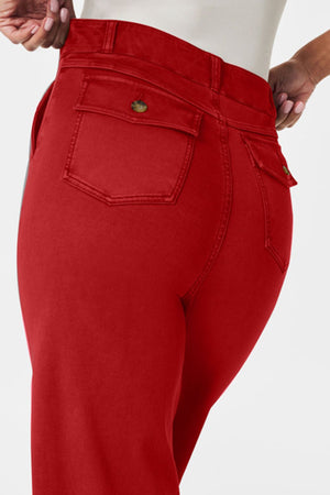 Red denim utility trousers with buttoned back pockets and wide legs.