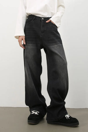 Oversized fade wash denim trousers in dark, wide leg, casual style.