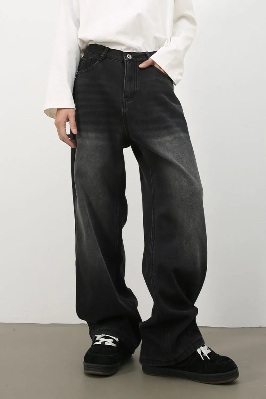 Oversized fade wash denim trousers in dark, wide leg, casual style.