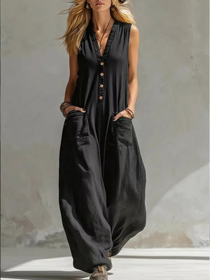 Black linen blend sleeveless wide leg jumpsuit with V-neck and button front, featuring large patch pockets.