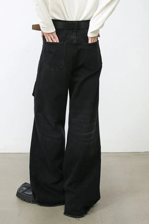 Dark denim cargo pants with wide legs and frayed hems.