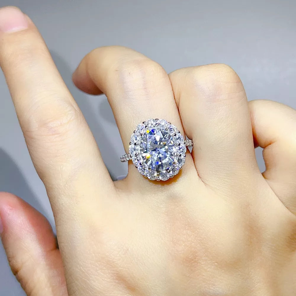 ring in silver featuring halo setting and oval fit