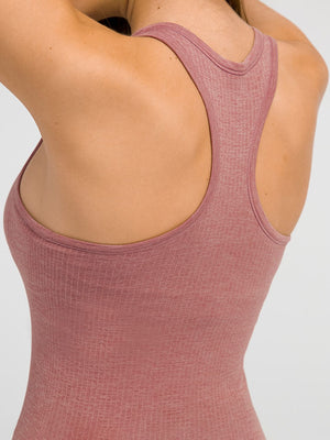 Ribbed dusty pink racerback performance tank top with a scoop neck.