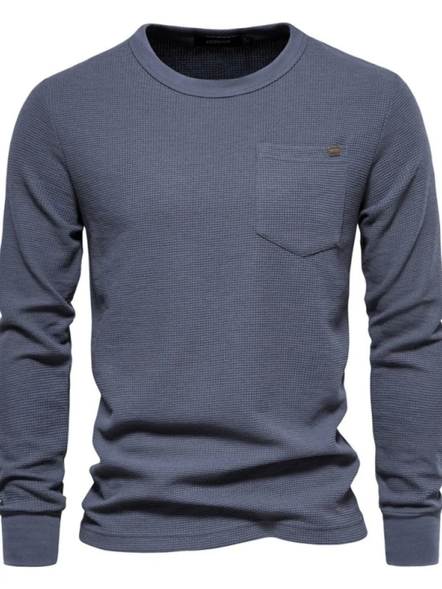 Gray textured thermal long sleeve tee with crew neck and chest pocket.