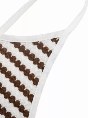 Halter neck midi dress with brown and white stripe pattern and textured fabric.
