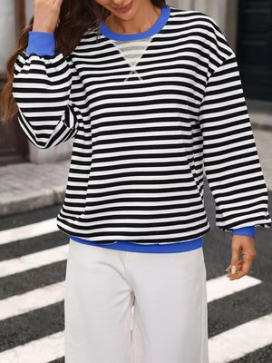 white sweatshirt featuring seam detail and striped