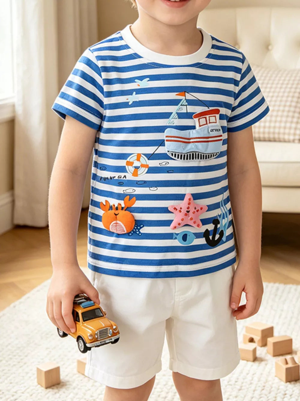 Children's blue and white striped short sleeve tee with nautical applique details.