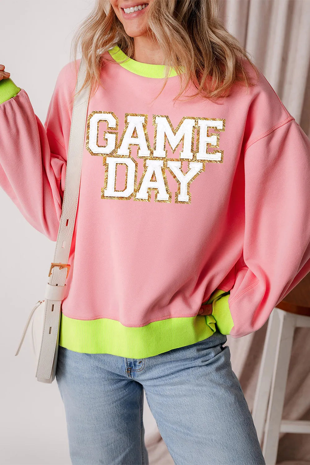 Pink sweatshirt with "GAME DAY" appliqué and neon trim