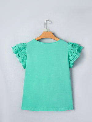 Eyelet lace ruffled cap sleeve top in mint green with cutout detail on sleeves.