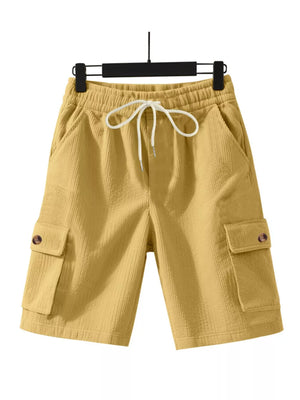 Yellow textured drawstring cargo shorts with button flap pockets.