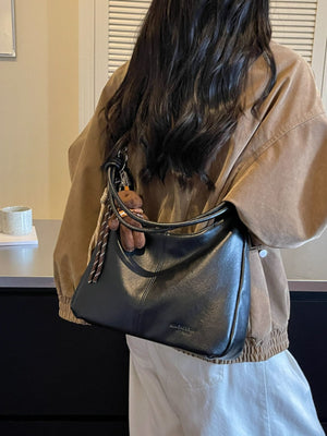 crossbody bag in black featuring stitching detail and relaxed fit