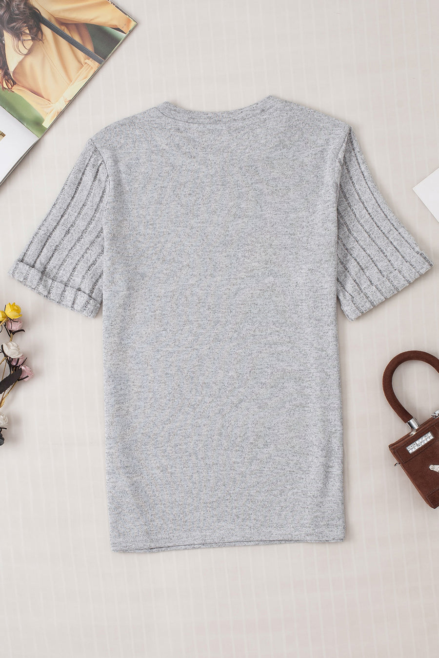 Gray t-shirt with ribbed short sleeves and a rolled cuff detail.