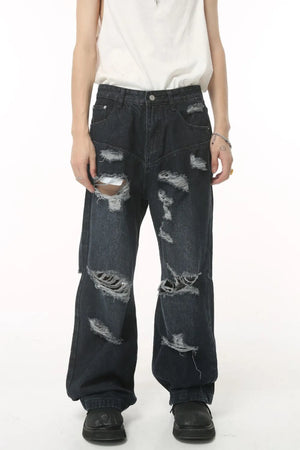 Distressed baggy dark wash denim jeans with statement rips and a relaxed fit.