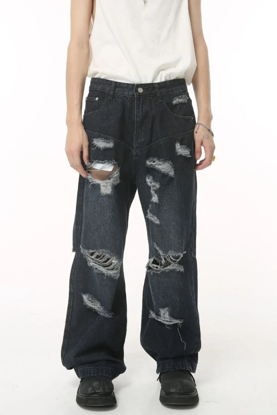 Distressed baggy dark wash denim jeans with statement rips and a relaxed fit.