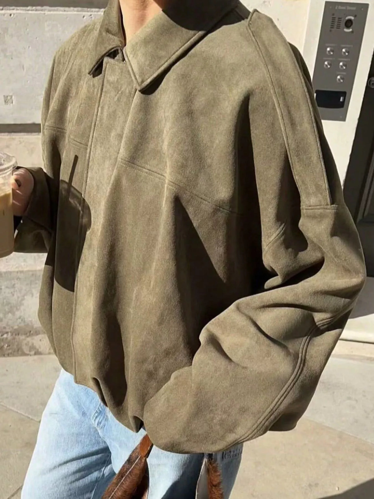 Oversized military green zip-up jacket with a suede-like texture and casual fit.