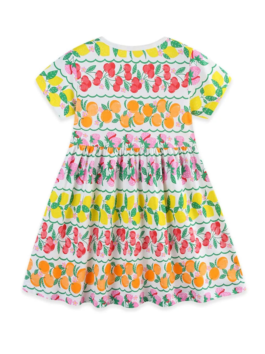 Girls white short sleeve dress with fruit print and tiered skirt.