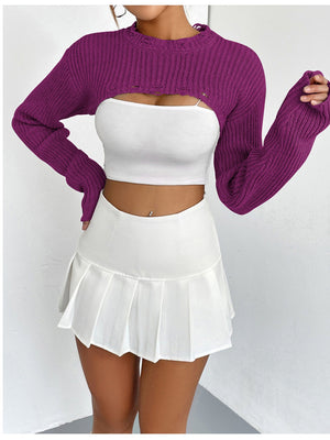 Fuchsia distressed knit bolero crop top with ripped details and long sleeves.