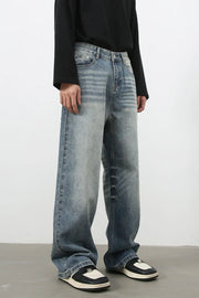 Baggy wash denim jeans in medium blue with a relaxed fit and faded details.