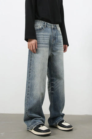 Baggy wash denim jeans in medium blue with a relaxed fit and faded details.