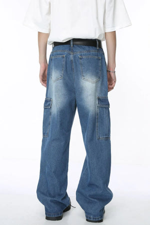 Pleated wide-leg denim cargo pants in medium blue wash with cargo pockets.