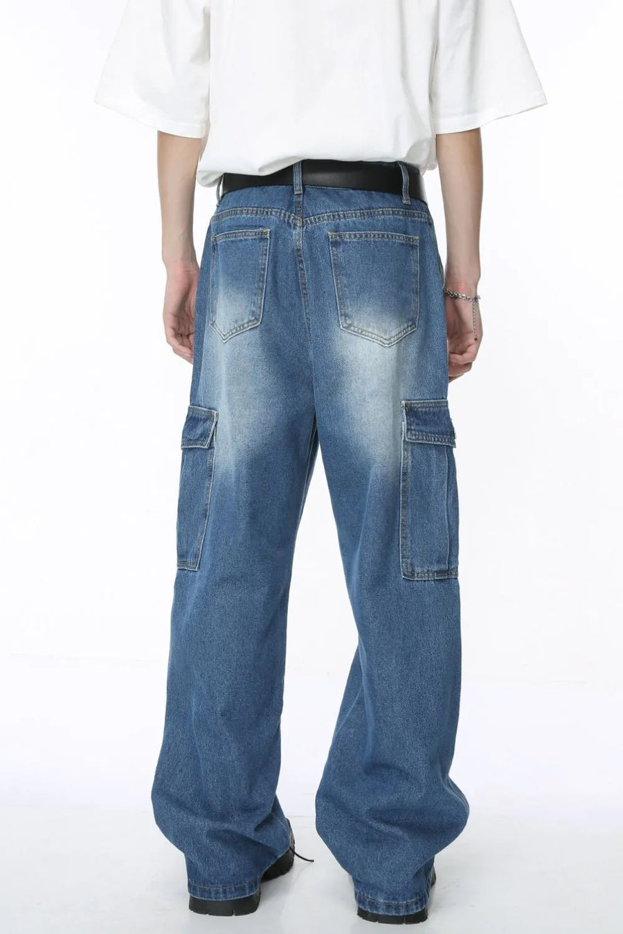 Pleated wide-leg denim cargo pants in medium blue wash with cargo pockets.