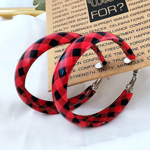 Red and black buffalo check statement hoop earrings with alloy hardware.
