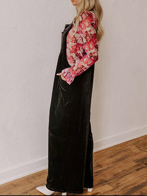 Black velvet wide-leg maternity romper with pockets, styled with a floral top.