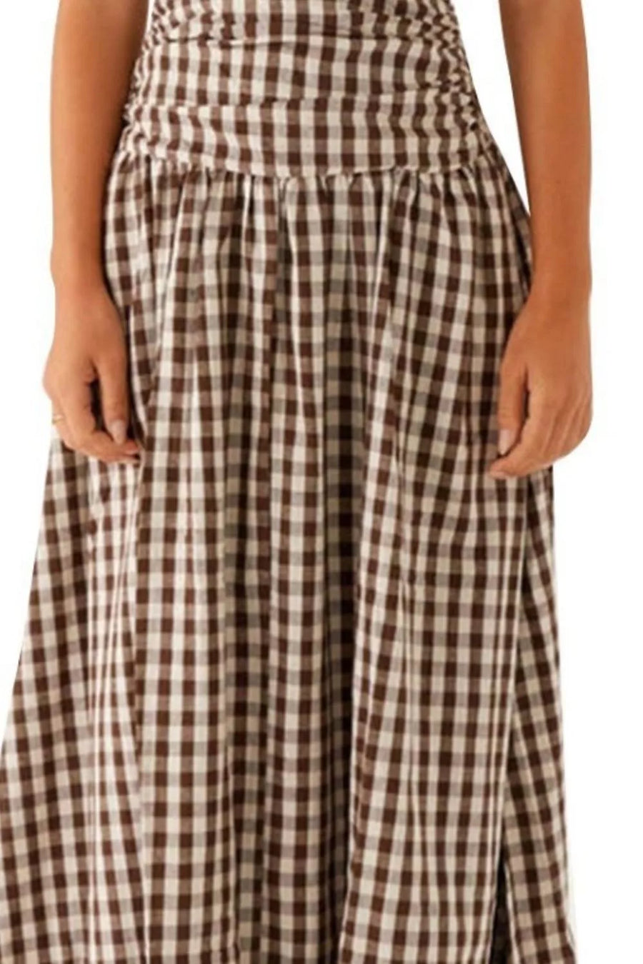 Ruched maxi dress with flowing skirt in brown and white gingham pattern.