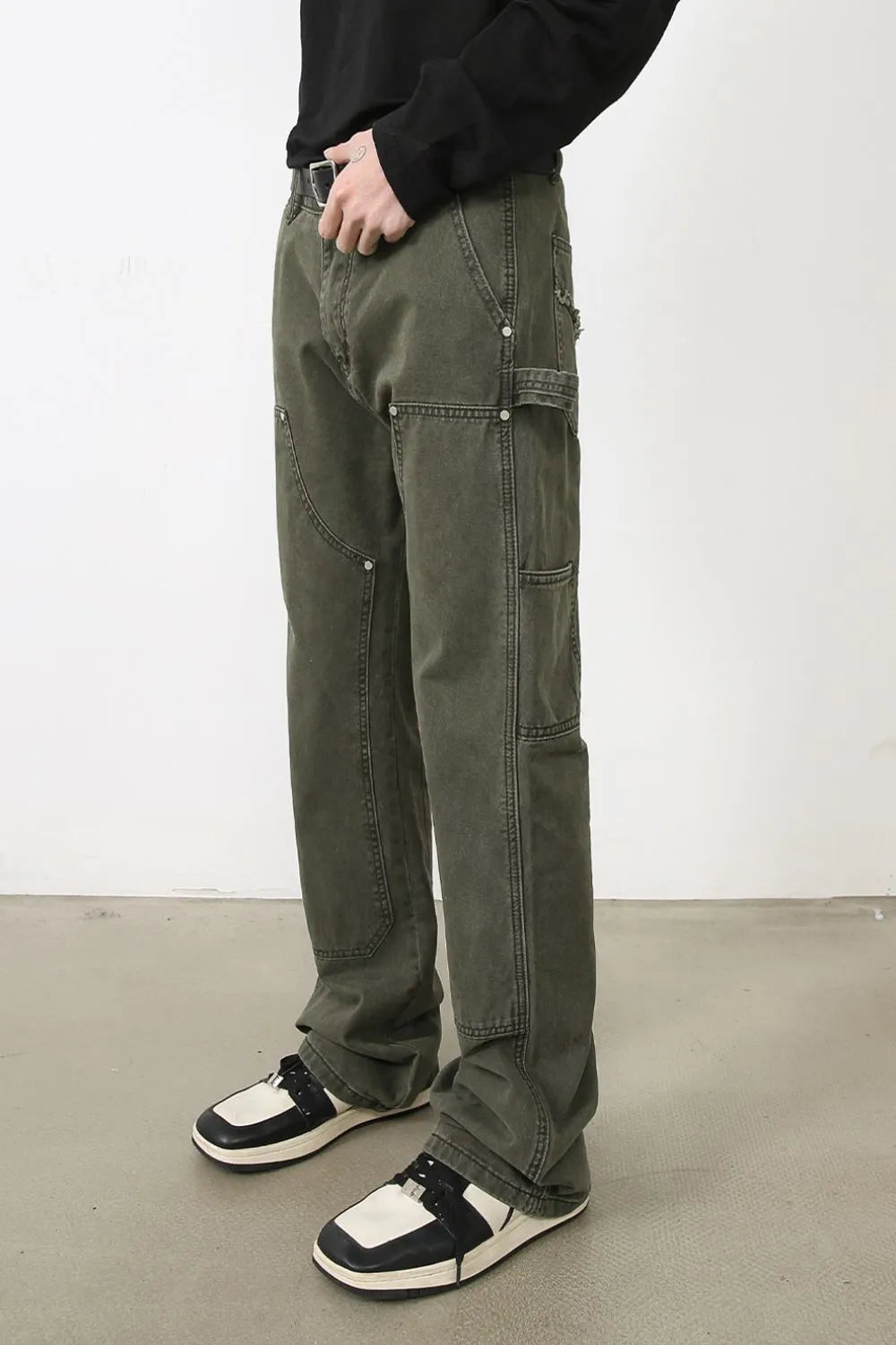 Army green utility jeans with wide legs and multiple pockets.