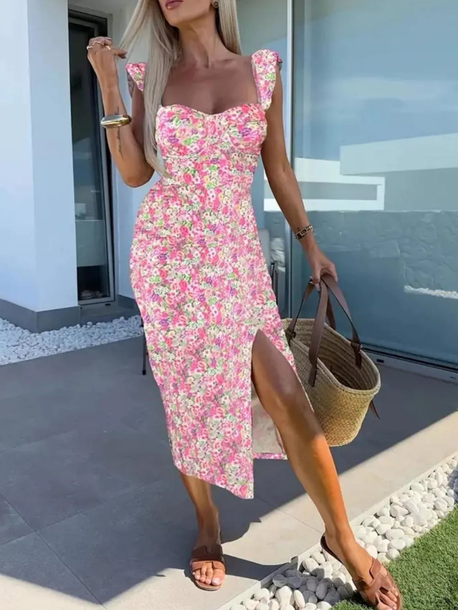 Floral sweetheart midi dress with slit in pink floral print, featuring ruffled cap sleeves and a bustier top.