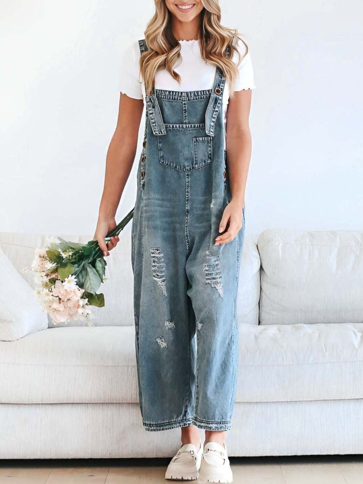 Ripped relaxed fit denim overalls in light blue with adjustable straps and button sides