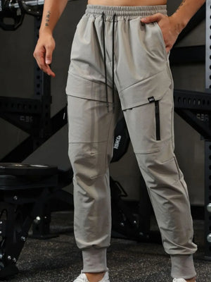Technical joggers in gray with zip pockets and cargo details.