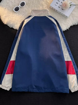 Men's blue track jacket with white and red panel details and a stand-up collar.