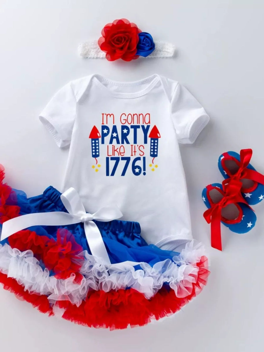 White baby onesie with "I'm Gonna Party Like It's 1776!" text, red & blue tutu, headband, and star shoes.