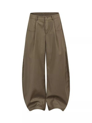 Brown pleated front wide-leg trousers with elastic waistband and adjustable fit.