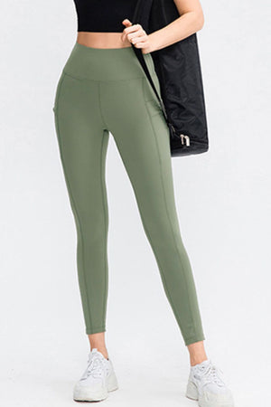 Sage green athletic leggings with pockets and a high waist.
