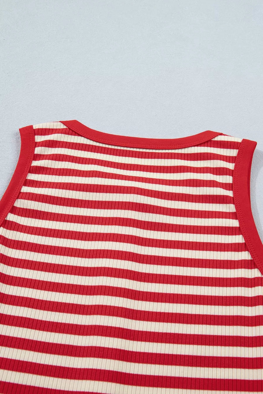 Red and cream striped ribbed knit tank top with red trim.