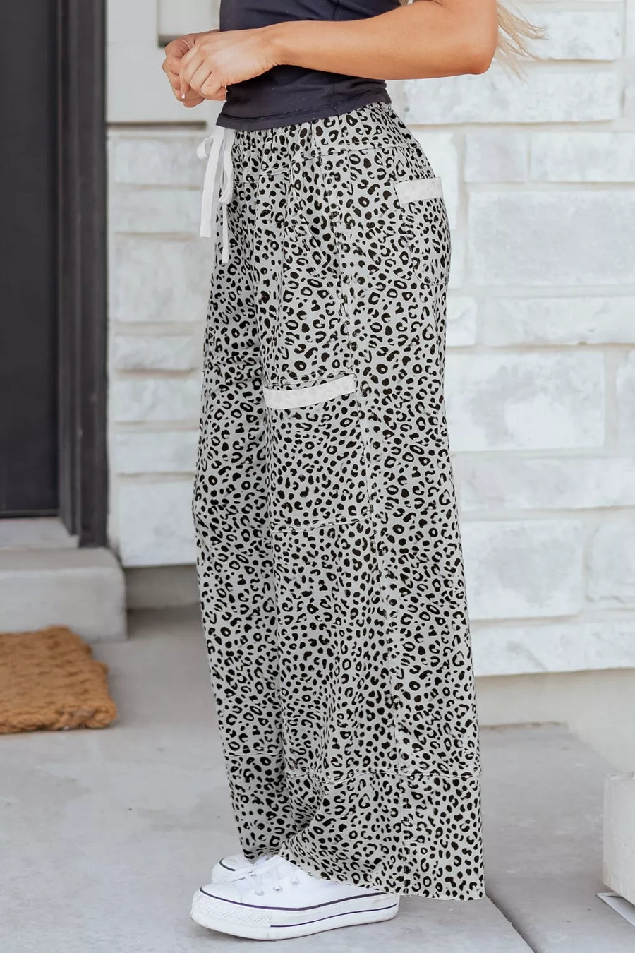 Animal print wide leg pants with drawstring waist and white trim pockets.