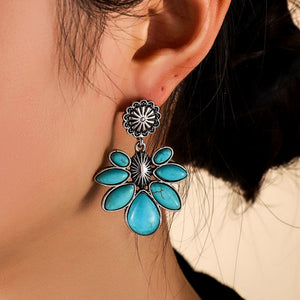 Teal petal drop earrings with silver flower detail, alloy material.