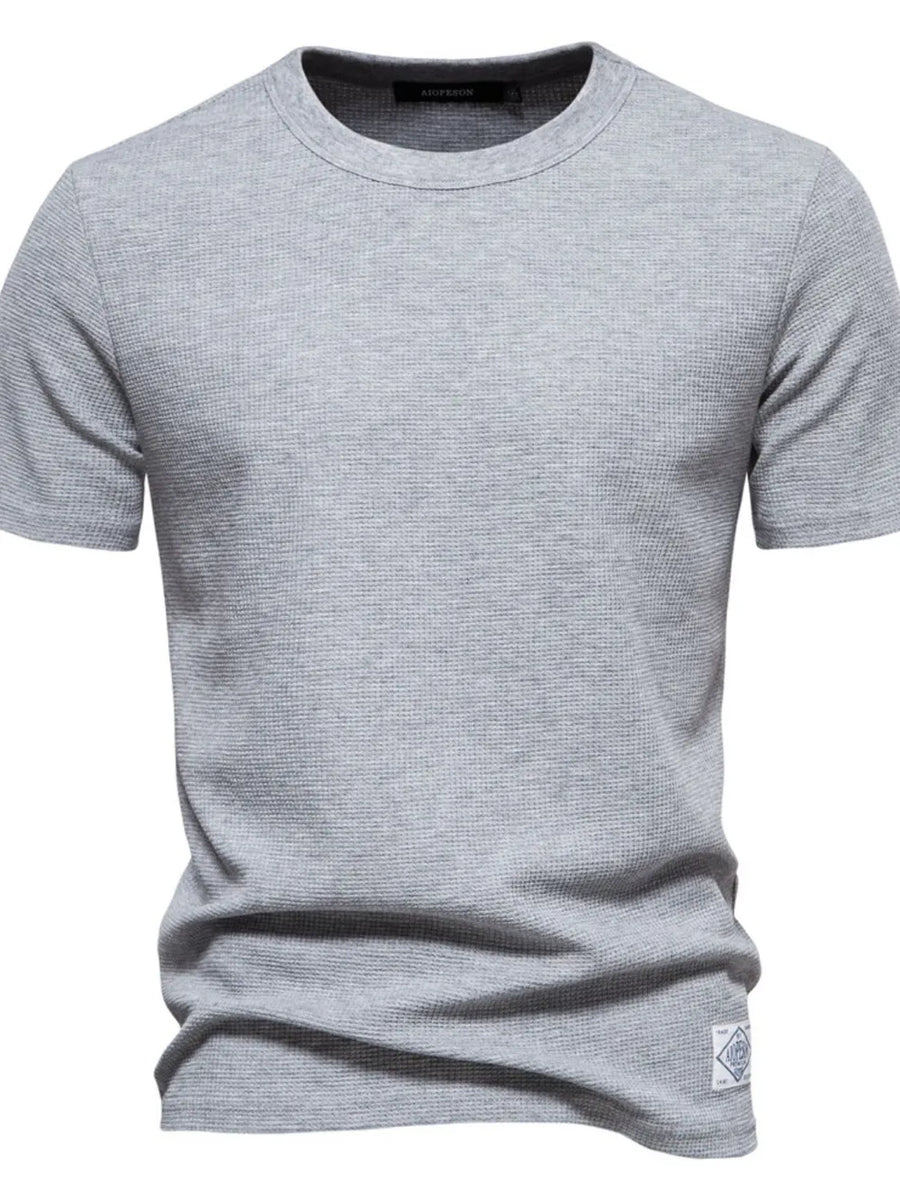 Gray textured crew-neck t-shirt knit with short sleeves and a small logo patch.