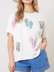White polyester t-shirt with allover pink and green flip-flop print