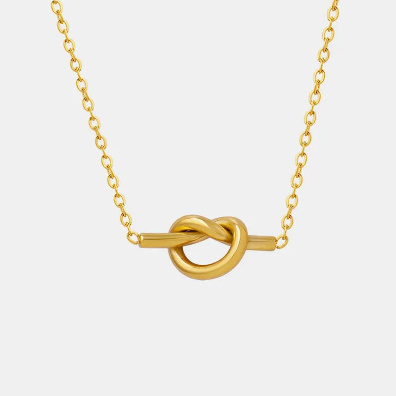 Gold tied bar pendant necklace with delicate chain
