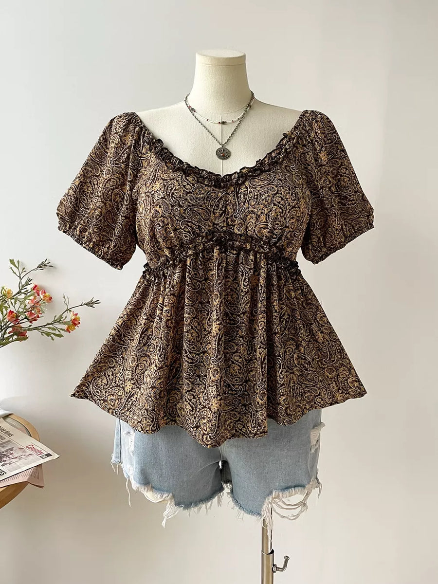 Plus size coffee brown paisley print peasant blouse with ruffled neckline and smocked waist.