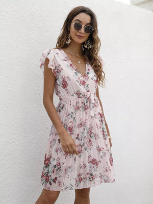 Blush pink floral pleated dress with ruffle sleeves and a belted waist.