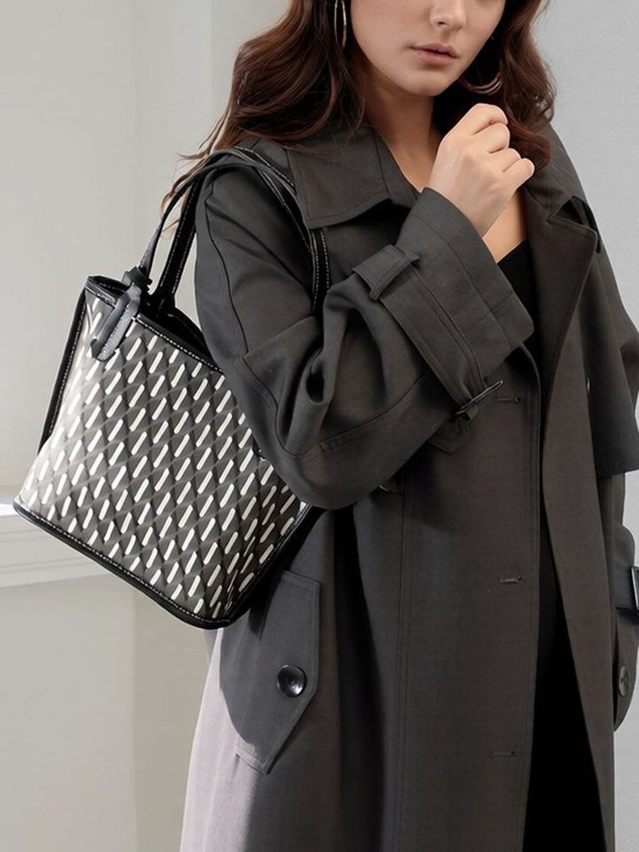 white handbag featuring detachable purse and geometric